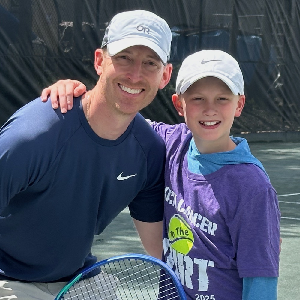 Josh Sprecher coaching a young player on court